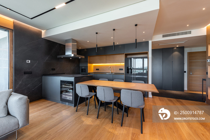 Luxury kitchen and dining room interior with brown parquet floor