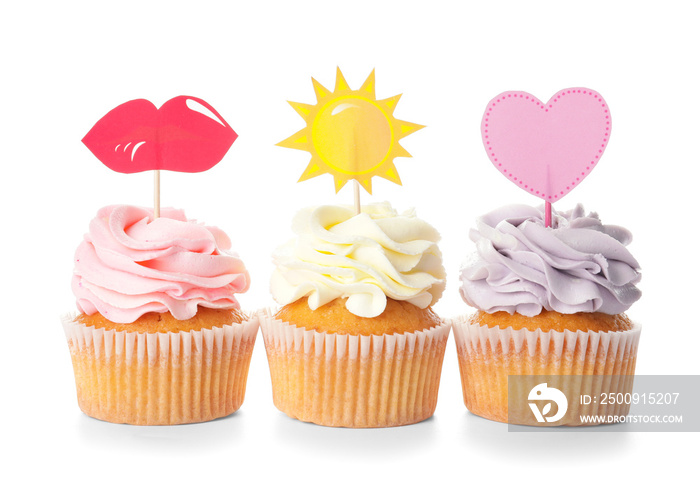 Tasty cupcakes with stylish toppers on white background