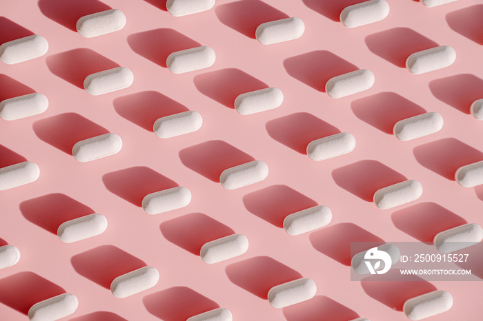 White pill pattern on a pink background.