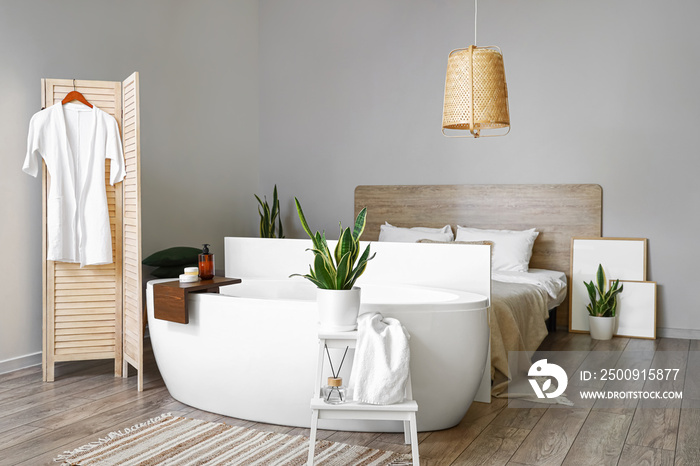 Interior of modern bedroom with bathtub