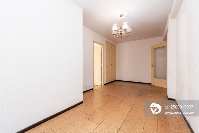 Empty room with cork tile flooring and cream painted wooden doors