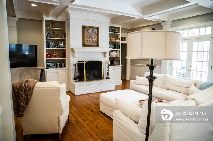 Large Living Room Den in Home with Vaulted Tray Ceiling and bookshelves