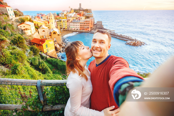 Tourists happy couple taking selfie photo of Vernazza, national park Cinque Terre, Liguria, Italy, E