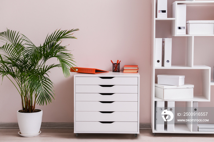 Interior of room with modern chest of drawers