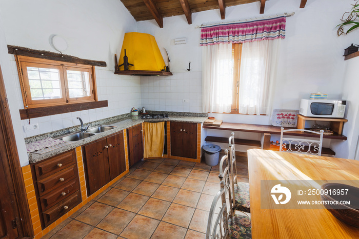 Living room and kitchen inside an old style rural rental house.