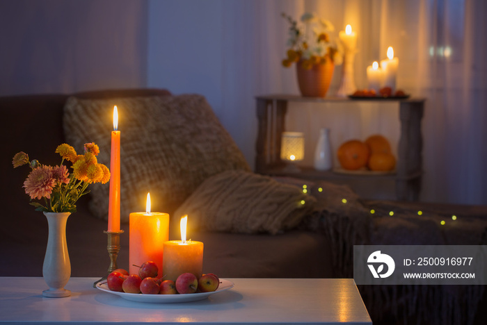 autumn decorations with burning candles at home