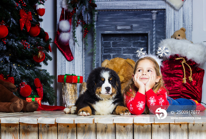 Christmas child and puppy on New Year`s background