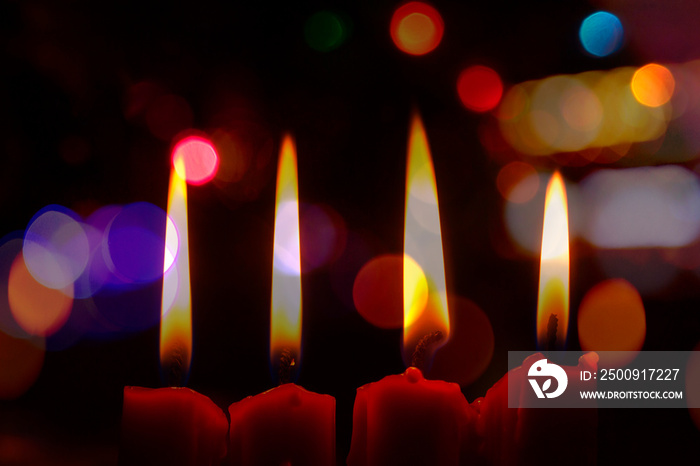 Four Red Candle on the table in Christmas night with bokeh light effected