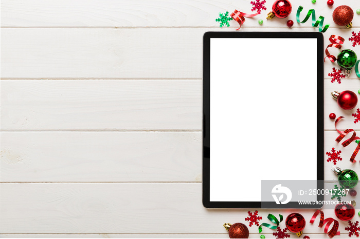 Christmas online shopping from home tablet pc with blank white display top view. Tablet with copy sp