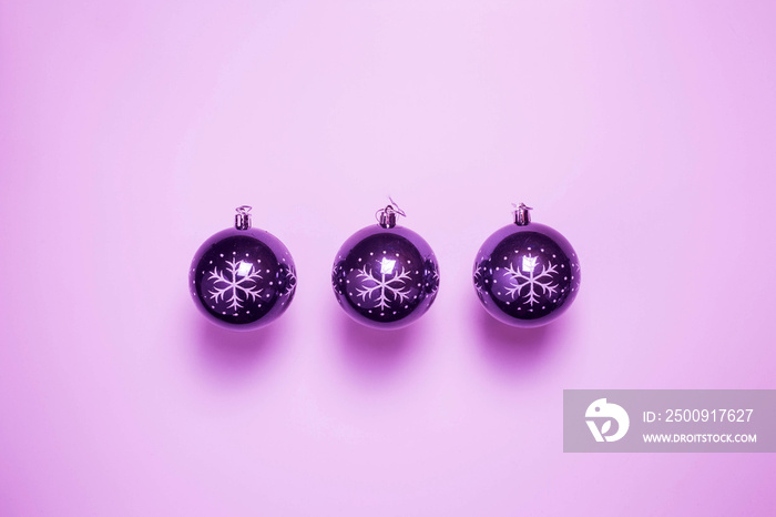 Purple Christmas ornament, christmas balls in a row near purple background, retro design