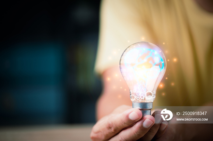 a light bulb in the hands of a young businessman ,