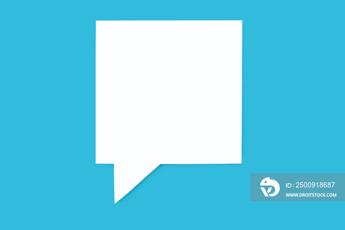 Paper speech bubble in the shape of a square on a blue background. Flat white chat icon in the form 