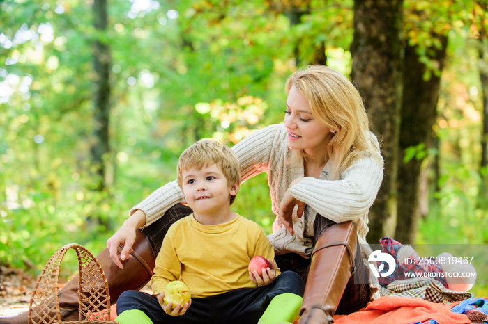 Spring mood. Happy family day. Happy son with mother relax in autumn forest. Mother love her small b
