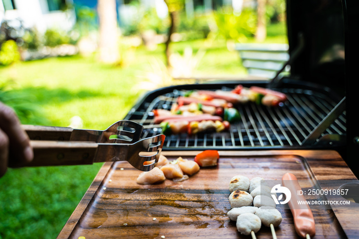 BBQ grilled party at outdoor garden hand close up