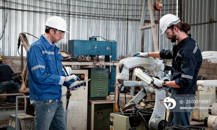 Engineer factory industry wearing safety uniform work and checking system of the welding robots for 