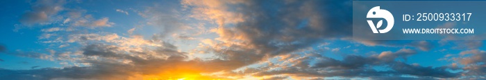 Panorama Sunlight with dramatic sky. Cumulus sunset clouds with sun setting down on dark background.Vivid orange cloud sky.