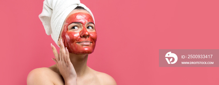 Beauty portrait of woman in white towel on head with gold nourishing mask on face. Skincare cleansing eco organic cosmetic spa relax concept.