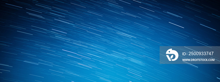 startrails on a dark blue sky at night