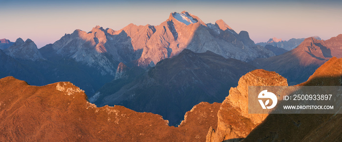 Autumn view of the Passo Giau valley in the Italian Dolomites and the snow-capped Marmolada glacier. Marmolada is the highest mountain, Dolomiti, northern Italy. Dolomites on a beautiful autumnal day.