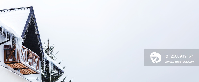 Icicles on the snow-covered roof, winter card, panoramic mock-up with space for text