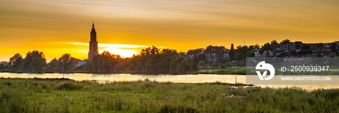 Skyline of the city of Rhenen during sunset with Cunera church and river Nederrrijn in the provence of Utrecht in the Netherlands