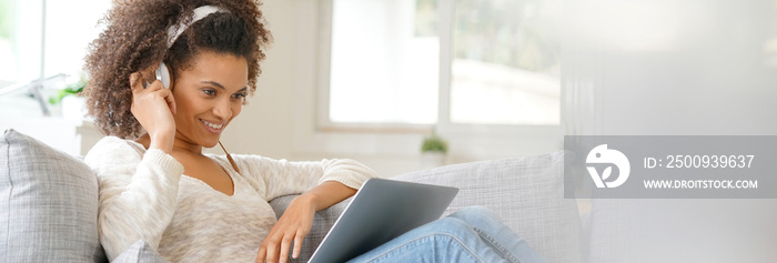 Cheerful woman making a videocall on laptop computer