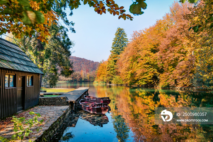 Stunning morning view of pure water lake with boats in Plitvice National Park. Amazing autumn scene of Croatia, Europe. Beauty of nature concept background.