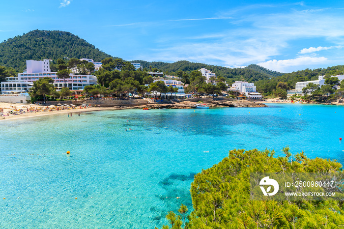 View of Cala Portinatx bay with hotel buildings in background, Ibiza island, Spain