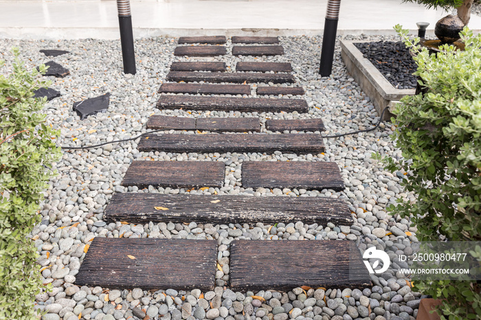 Stone walkway winding in garden. Stone block pathway and gray gravel in the park. landscape path in the garden.