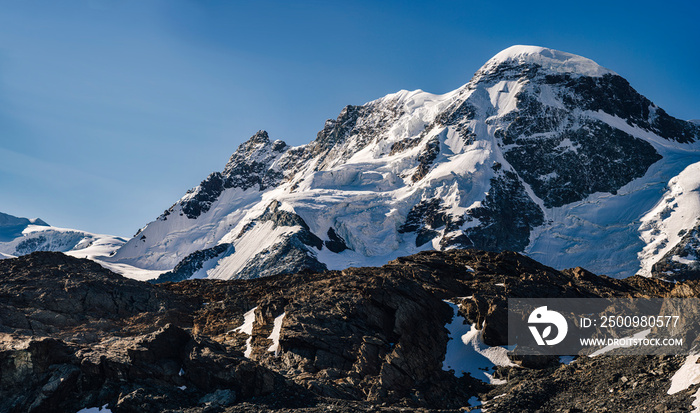 Panorama view of Breithorn, 4000 m alpine peak in Switzerland. High resolution photo of an alpine north face of Breithorn, swiss mountain above Zermatt. Mountain alpine landscape with seracs and snow.