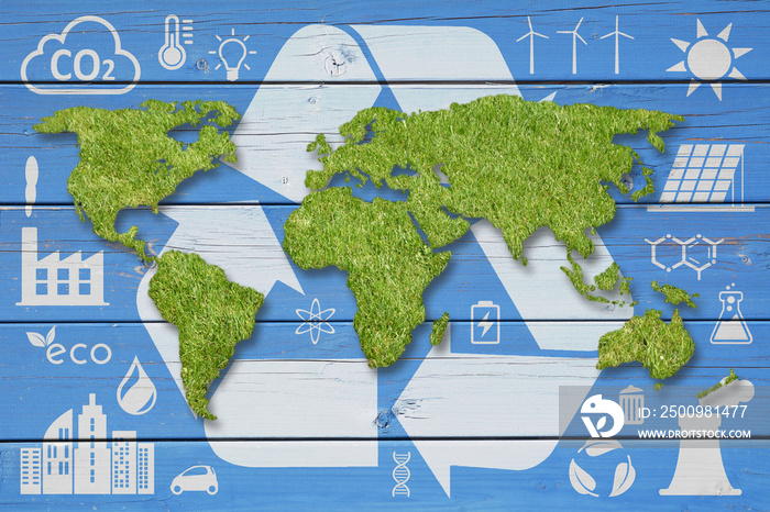 Green grass World Map, white recycling symbols and ecology icons on blue wood backdrop. Ecology concept background.