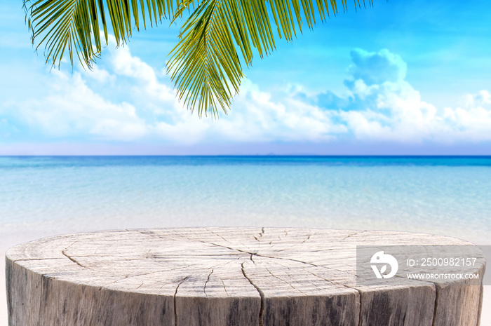 Wooden desk or stump on sand beach in summer. background. For product display