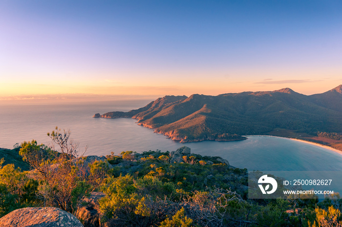 Sunrise landscape of ocean coastline with mountains and beach