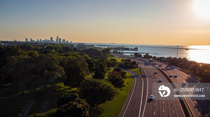 Coastal highway approaching distant city skyline at sunset- Cleveland, OH