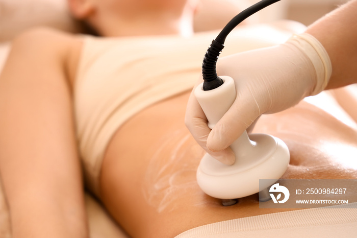 Young woman undergoing anti-cellulite treatment in beauty salon, closeup