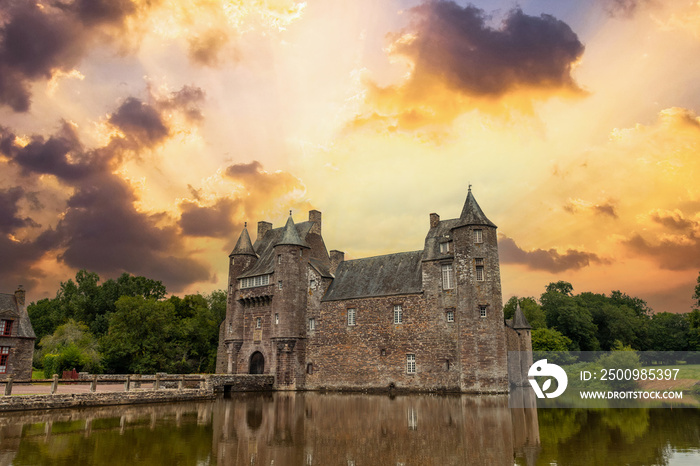 Sunset on the beautiful lake of Chateau Trecesson, medieval castle, Campénéac commune in the Morbihan department, near the Broceliande forest.