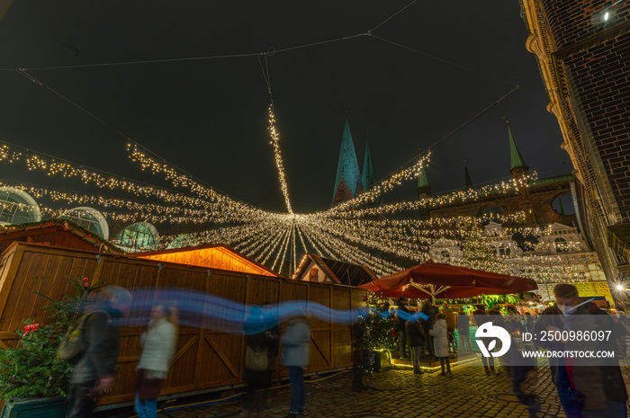 Christmas market in Germany. Christmas atmosphere of the city at evening. Christmas market in the historic center of the city. Christmas Fair at night, Lubeck, Germany, Europe