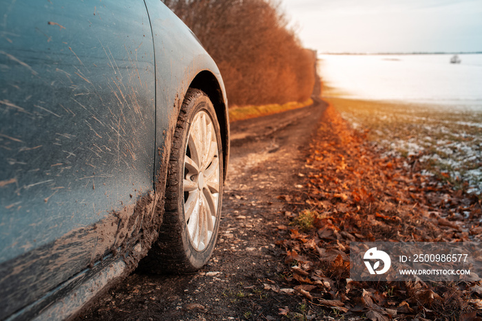 Close-up of muddy wheel of car on road. Offroad driving.