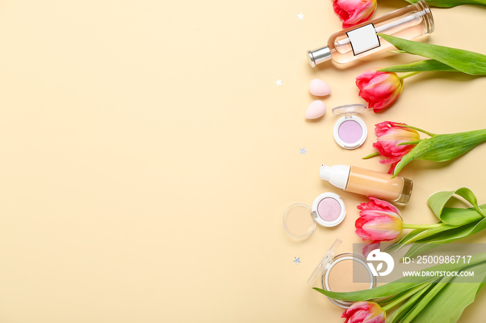 Composition with beautiful tulip flowers, cosmetics and makeup sponges on color background