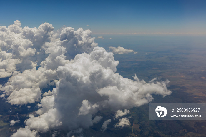 Overview of fluffy clouds in mountains from an airplane, Arizona