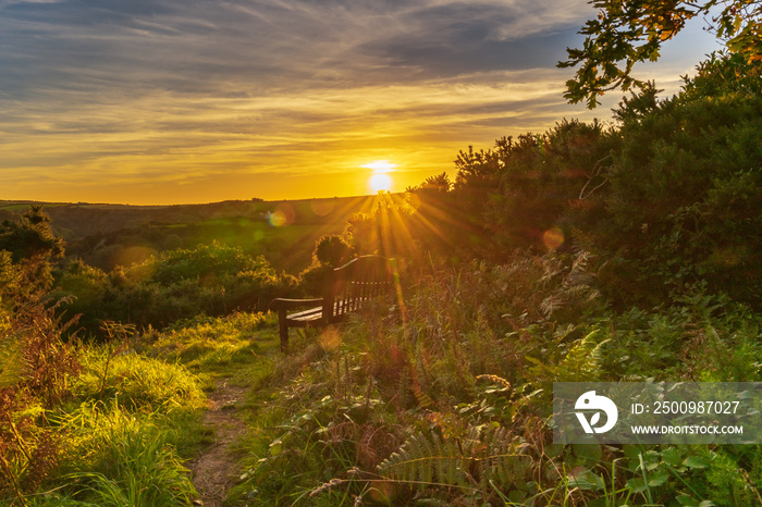 A bench in the sunset, seen in Ilfracombe, North Devon, England, UK