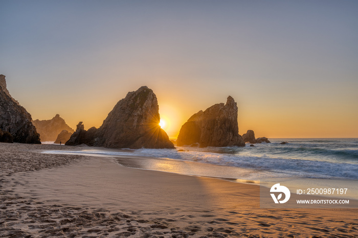 Beautiful sunset on a beach with sea stacks at the portuguese atlantic coast