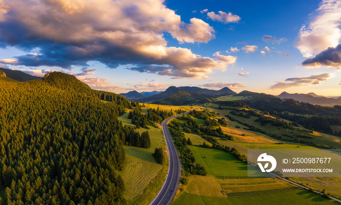 Road going through forests of the Liptov region in Slovakia at sunset