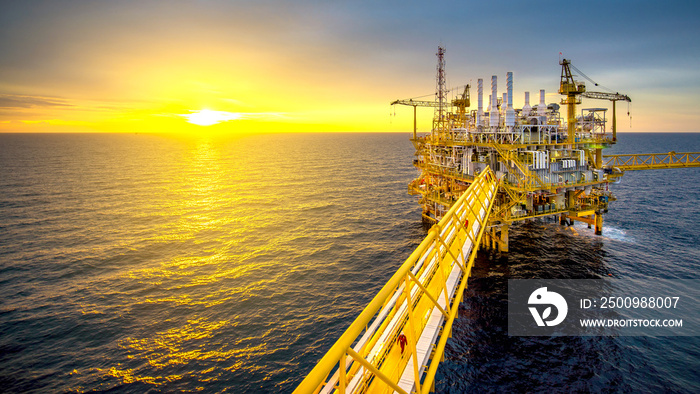 Large Offshore oil rig drilling platform at sunset and beautiful sky in the gulf of Thailand