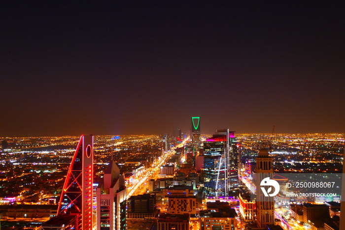 Panorama view to the skyline of Riyadh by night, with skyscrapers in the background and busy traffic on the streets of Riyadh, the capital of Saudi Arabia