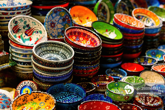 Stack of classical traditional Turkish ceramics, handmade colorful dishes at the Istanbul Egypt Bazaar (Misir Carsisi). Istanbul, Turkey souvenirs. Selected focus, copy space