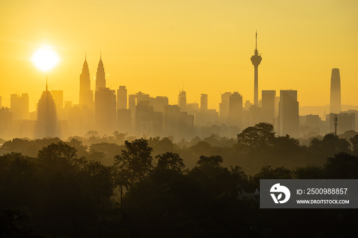 Majestic sunrise over downtown Kuala Lumpur. It’s modern skyline is dominated by 451m tall KLCC, a pair of glass-and-steel-clad skyscrapers with Islamic motif.