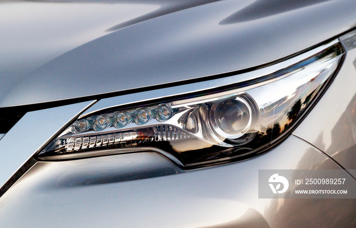 Car’s exterior details. Close up detail LED headlights on a modern car.