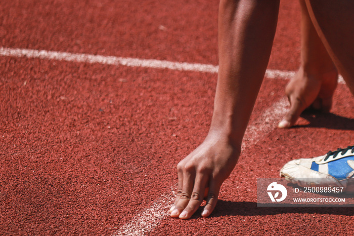 Cropped image of a sprinter getting ready to start at the stadium