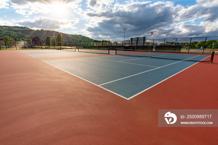 New blue tennis courts with white lines and red out of play area.